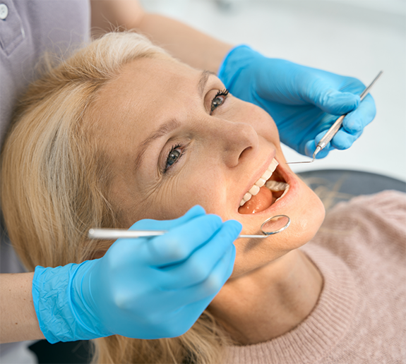 Senior woman sitting back in dental chair for dental exam