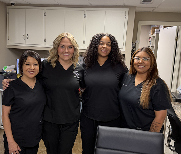 Little Rock dental team members standing in row and smiling