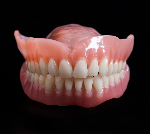 Full dentures on black background