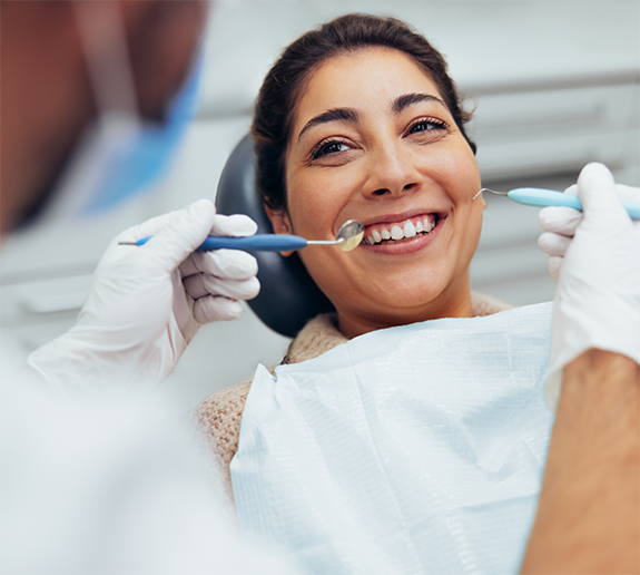 Woman smiling at dentist during checkup