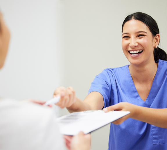 Taking clipboard from dental patient