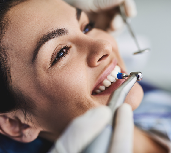 Female patient having teeth cleaned