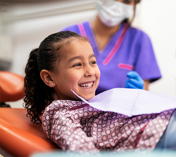 Little girl in dental chair smiling