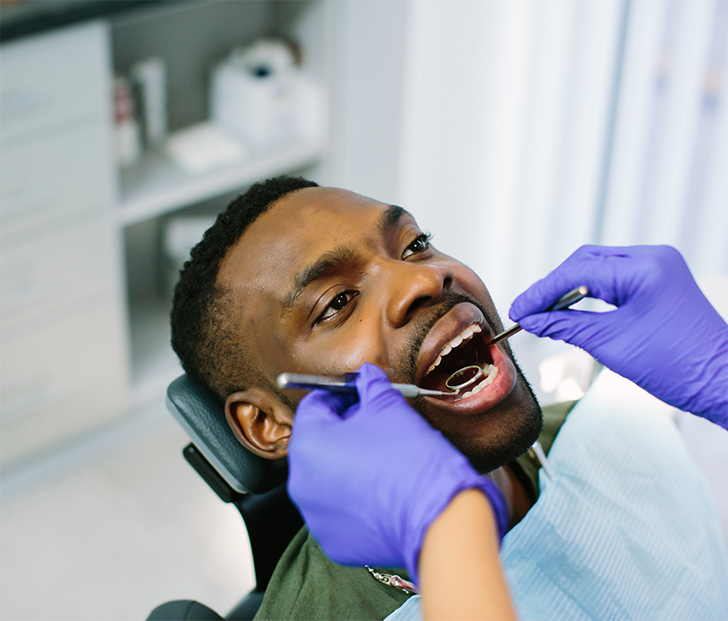 Man leaning back in dental chair for dental exam